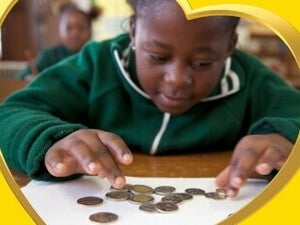 The child is counting coins