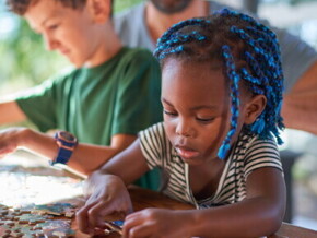 A girl puts together puzzles img